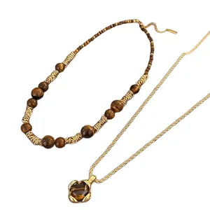 Elegantes Set aus Tigerauge-Perlenhalskette und Goldkette mit passendem Steinanhänger