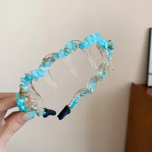Close-up detail of acrylic headband with irregular blue stone embellishments