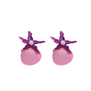 Vibrant purple starfish and pink shell stud earrings with a central pearl for beach vacation.