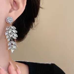 Close-up view of elegant silver floral wheat ear earrings with sparkling marquise crystals