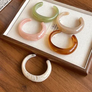 Chunky minimalist acrylic open bangles with elegant marbled finish in assorted colors.