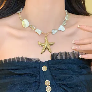 Detailaufnahme der unregelmäßigen Muschelkette mit goldenem Seestern-Anhänger