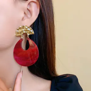 Vintage exaggerated red marbled resin U-shaped drop earrings with gold textured metal