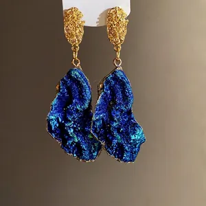 Elegant vintage gold-textured earrings with irregular blue druzy resin pendants