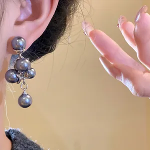 Close-up of elegant pearl grape cluster earrings in French vintage style