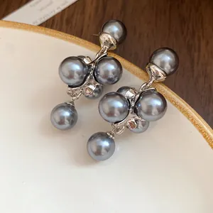 Close-up detail of grey pearl grape cluster earrings with a French vintage style design