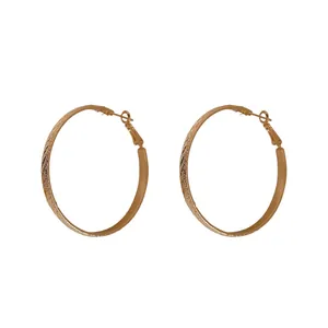 Elegant textured gold hoop earrings with diagonal shirred twill pattern for women
