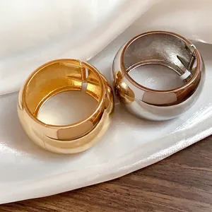 Chunky polished metallic cuff bracelets in gold and silver minimalist hinged bangles for women