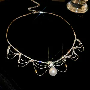 Macro detail of French style rhinestone pearl necklace with elegant dangling chains and sparkles