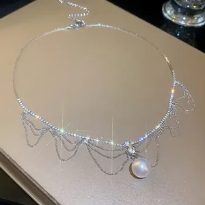 Close-up of elegant French style necklace with rhinestones and white pearl pendant