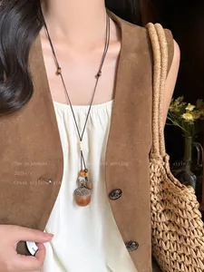 Detailed view of a handmade acorn pendant necklace featuring natural wooden beads and adjustable cord
