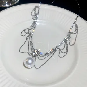 Macro detail of French style pearl pendant necklace with sparkling rhinestones