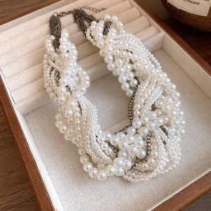 Close-up of vintage style multi-strand pearl necklace with elegant rhinestone detailing