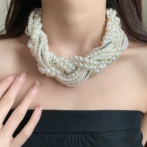 Elegant multi-layer white pearl necklace with sparkling rhinestone accents on a model's neck