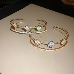 Elegant gold-plated open cuff bracelet with sparkling zircon four-leaf flower motifs