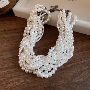 Detailed macro view of elegant multi-layered white pearl knotted necklace with rhinestone accents