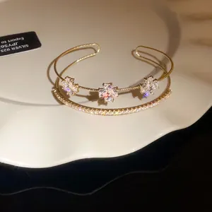 Detail view of an elegant zircon flower cross bracelet with sparkling gemstones