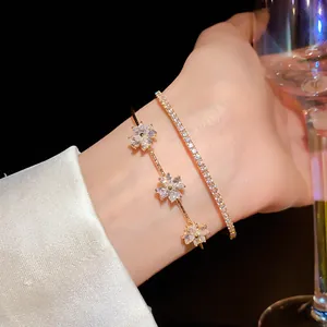 Detailed macro shot of an elegant gold flower bracelet set with sparkling cubic zirconia