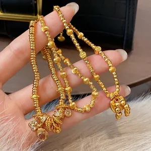Elegant gold-plated charm bracelets with intricate lock and bead designs for women.