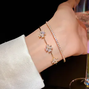 Detailed view of elegant gold flower zircon bracelet and sparkling tennis bracelet set