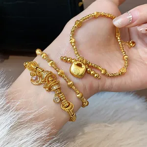Detailed view of gold-plated lock bracelet featuring traditional Chinese charm design