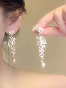Close-up of elegant French style pearl drop earrings with sparkling details