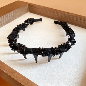 Elegant black mesh-wrapped headband with sparkling glass beads and decorative spikes for women.
