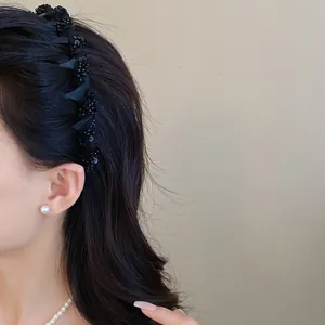 Close-up of black mesh headband with elegant glass bead embellishments for women
