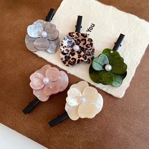 Elegant floral duckbill hair clips with pearl centers in assorted colors and patterns.