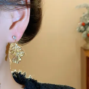 Elegant gold pleated leaf drop earrings with sparkling crystal stud detail for women