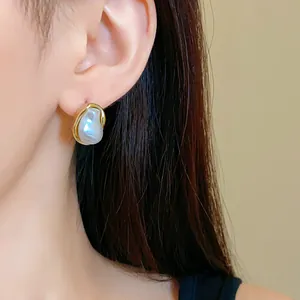 Detailed close-up showing a French retro irregular baroque pearl stud earring on an Asian model