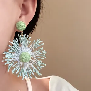 Handmade woven mint green flower firework earrings for vacation style.
