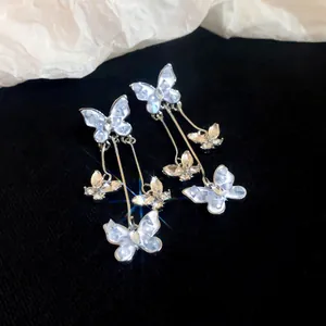 Close-up of elegant butterfly crystal tassel earrings with sparkling diamond-like accents