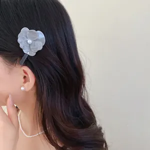 Side view detail of an elegant grey marble flower hair clip with center pearl