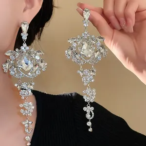 Macro view of luxurious silver tassel earrings with sparkling rhinestone water drop design.