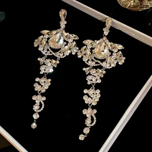Detailed view of sparkling luxury teardrop tassel earrings with crystal rhinestones