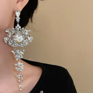 Detailed macro view of ornate silver tassel earrings with clear teardrop crystals