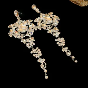 Detailed macro view of silver needle tassel earrings with sparkling teardrop crystals