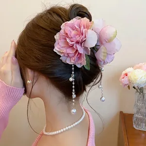 Elegant pink fabric flower hair clip with pearl tassels and shark clip for bun styling