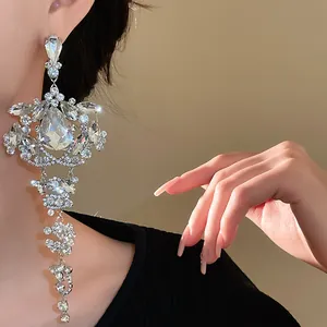 Elegant close-up of sparkling silver rhinestone waterdrop tassel earrings worn by model