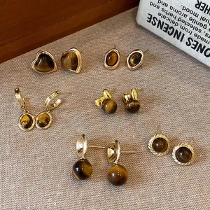 Vintage tiger eye stone earring collection in warm Maillard style brown and gold tones