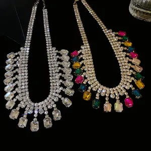 Detail shot of chunky rhinestone geometric statement necklaces on black background
