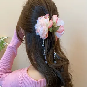 Elegant fabric flower hair claw clip with long pearl tassels for bun hair styles.
