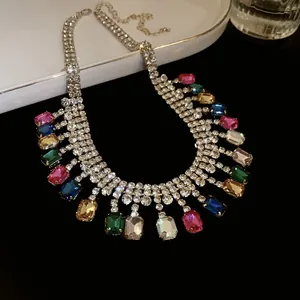 Close-up of statement rhinestone necklace with vibrant geometric colorful gems.