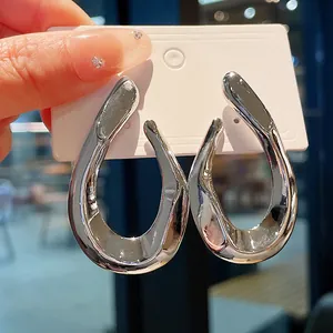 Close-up of chunky silver twisted metallic hoop earrings on display card