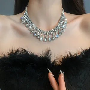 Detailed view of a glamorous silver-tone geometric rhinestone choker necklace on a model