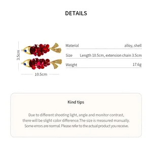 Detailed view of red fish-shaped hair clips with size and material specifications