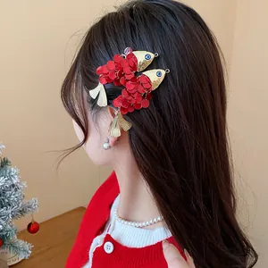 Detailed view of vintage red sequin fish hair clips worn on long dark hair side