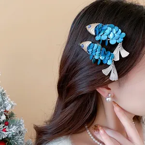 Close-up detail of vintage blue shell fish-shaped hair clips worn on long brown hair