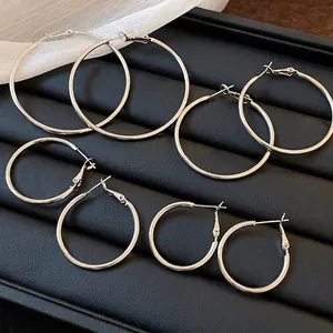 Minimalist silver circular hoop earrings set in various sizes for stylish women